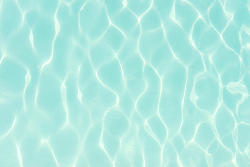 the fresh blue water of the swimming pool