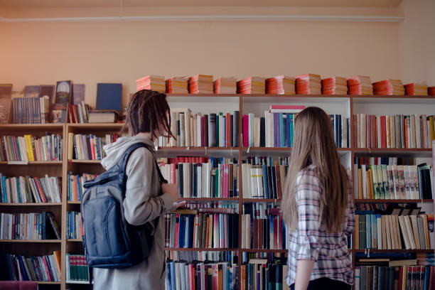 two caucasian students leaving each other. Horizontal shape, side view, waist up