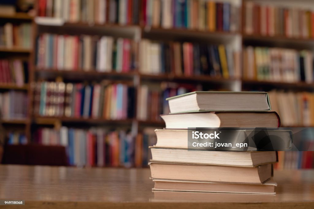 Books Close up of books on desk in library. Book Stock Photo
