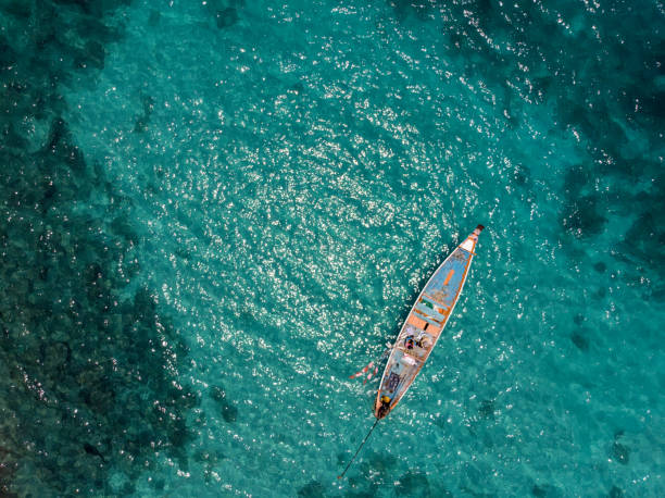 aerial view of traditional fisher boat in turquoise sea stock photo