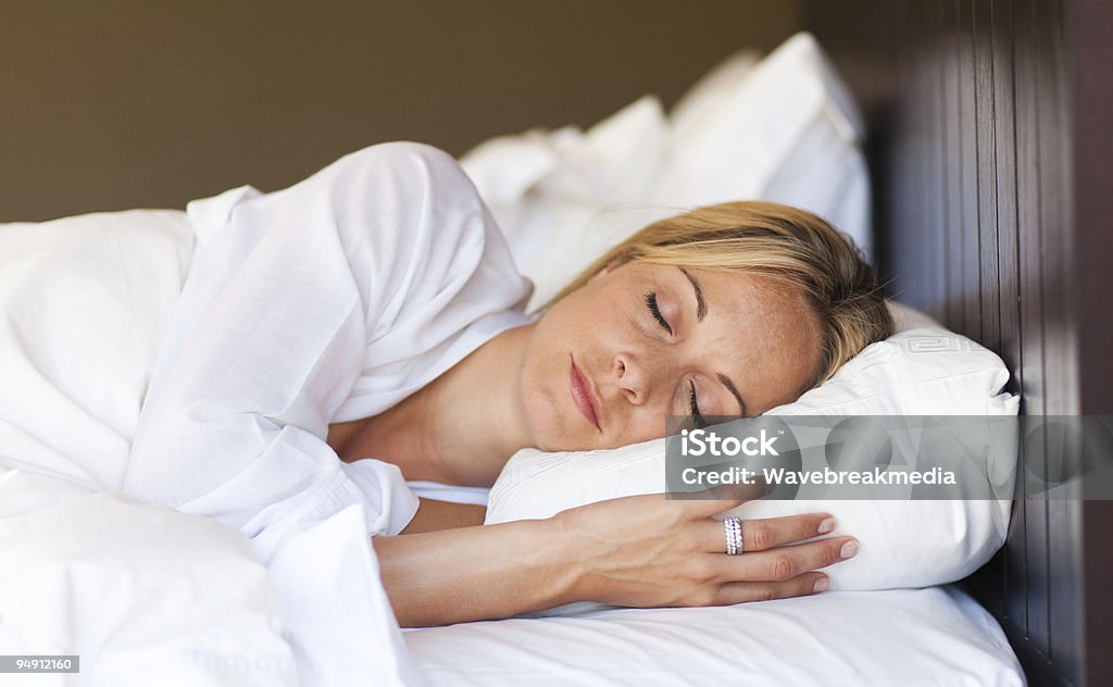 Young woman relaxing in bed Attractive young woman relaxing in bed 30-39 Years Stock Photo