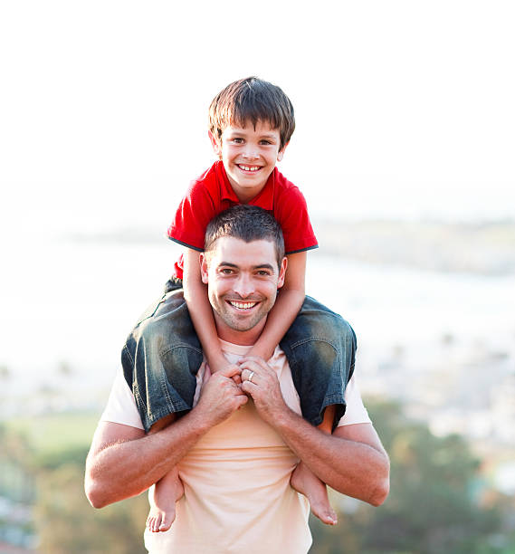 Portrait of boy (9-10) with his father, smiling, portrait
