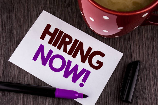 istock Word writing text Hiring Now Motivational Call. Business concept for Workforce Wanted New Employees Recruitment written on White Sticky Note Paper on the wooden background Cup Marker 949123696