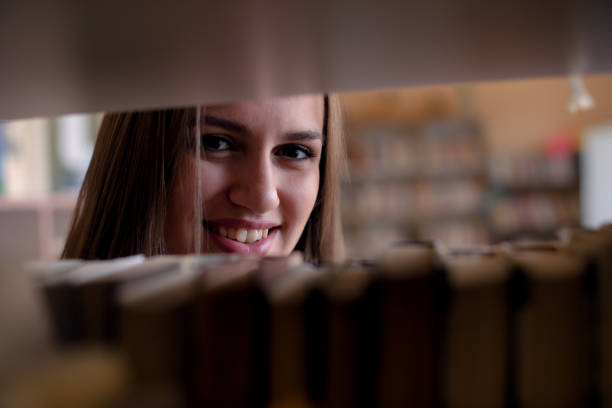 istock Beautiful woman in library 949123890