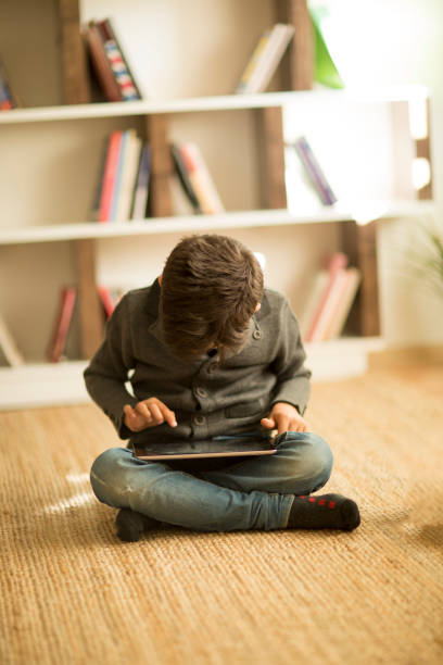 istock Cute Little Child Playing Game On Digital Tablet 949131274