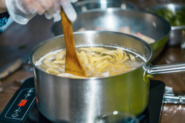 istock Chef stir Spaghetti in a pot of boiling water. cooking spaghetti. 949131348