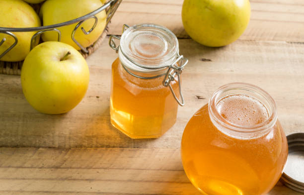 istock Home made apple jelly jars on rustic wooden table 949134376