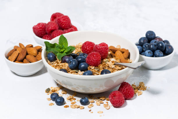 istock healthy breakfast. granola, fresh berries and fruits on white table 949138680