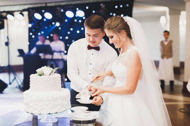 istock Bride and groom at wedding cutting the wedding cake 949160694