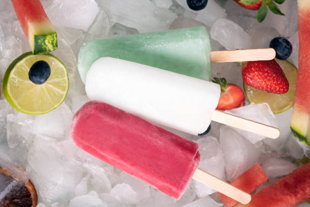 istock Homemade  popsicles on ice and fruits, top view 949164074