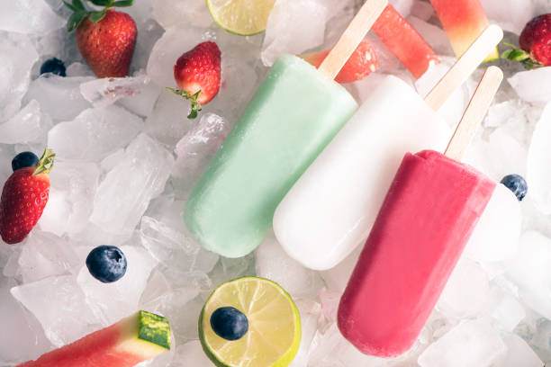 istock Homemade  popsicles on ice and fruits, top view 949164286