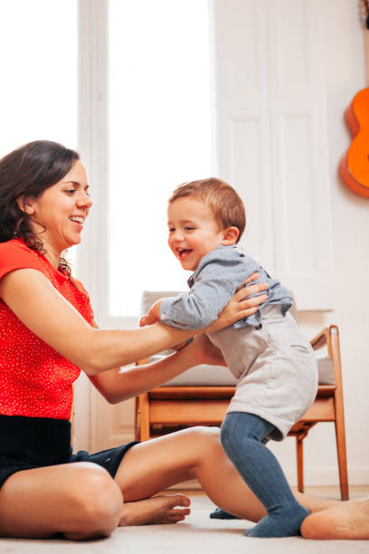 istock Mother and son playing on the floor 949167148