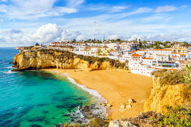 istock Sandy beach between cliffs and white architecture in Carvoeiro, Algarve, Portugal 949170380