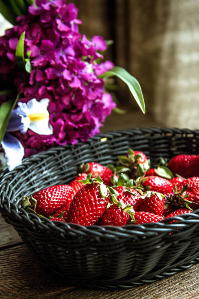 istock Fresh spring strawberries in black basket 949173462