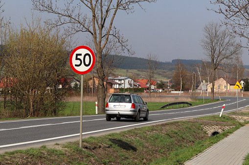 Yaslo/Jaslo, Poland - april 18, 2018: Limiting the speed of traffic to 50 km/h. Road sign on the highway. safety of traffic. Motor transportation of passengers. The car is moving along the road.