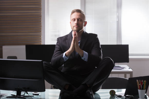 istock Businessman Meditating In Office 949177596