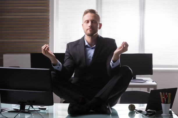 istock Businessman Meditating In Office 949177606