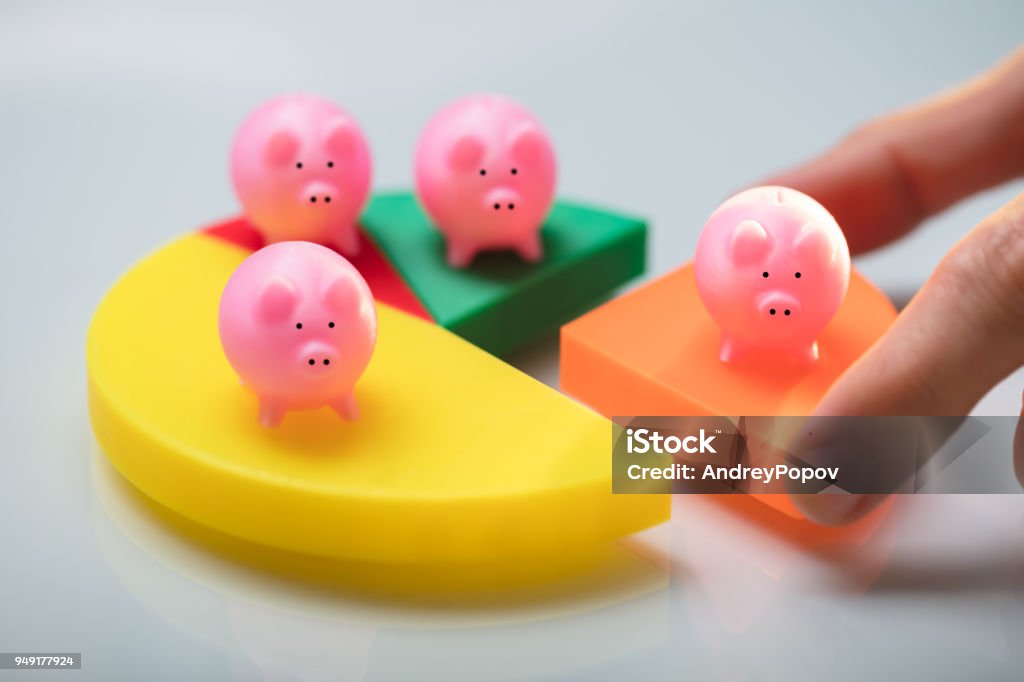 Person Placing Last Piece Into Pie Chart With Piggy Bank Person's Hand Placing Last Orange Piece Into Pie Chart With Small Pink Piggy Bank Pension Stock Photo