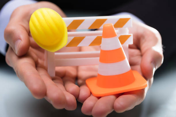 istock Close-up Of Barricade With Traffic Cone And Hard Hat 949178078