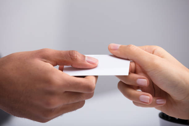 istock Two Businesspeople Holding Card 949182924