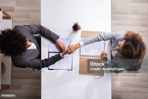 Male Manager Shaking Hands With Female Applicant Stock Photo - Download Image Now - Recruitment, Law, Interview - Event