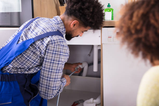 istock Male Plumber Cleaning Clogged Pipes 949183370