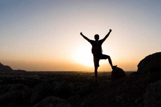istock Hiker on the mountain top facing the sunset 949186168