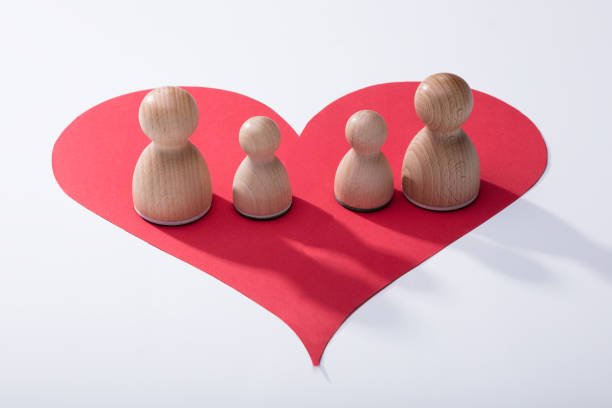 istock Wooden Pawns On Red Heart Shape 949186530