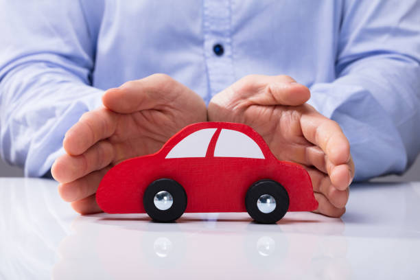 istock Person Protecting Red Car 949186646