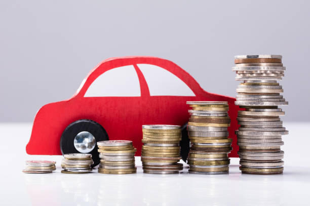 istock Stacked Coins In Front Of Red Car 949186698