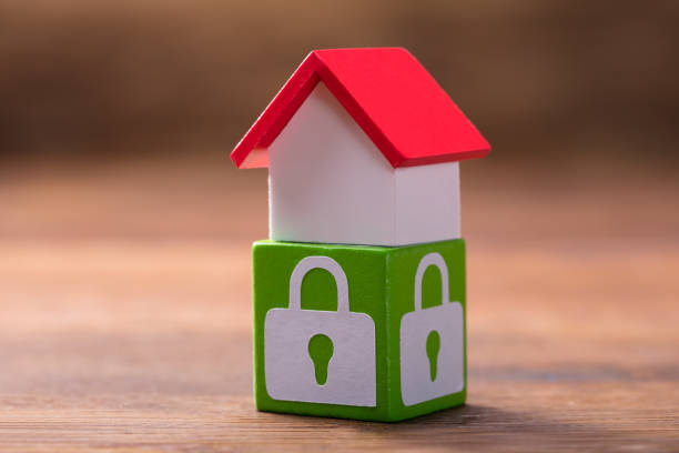 istock House Model On Green Block With Lock Symbols 949187410
