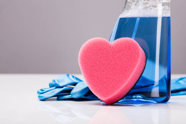 Spa composition with heart shaped soap towel closeup on blurred white background.