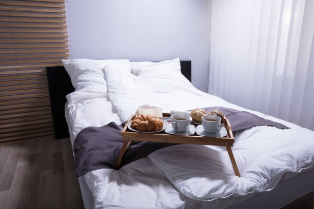 istock Croissants And Cup Of Tea On Bed 949189854