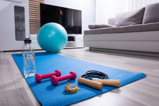 istock Skipping Rope And Pink Dumbbells On Exercise Mat 949189988