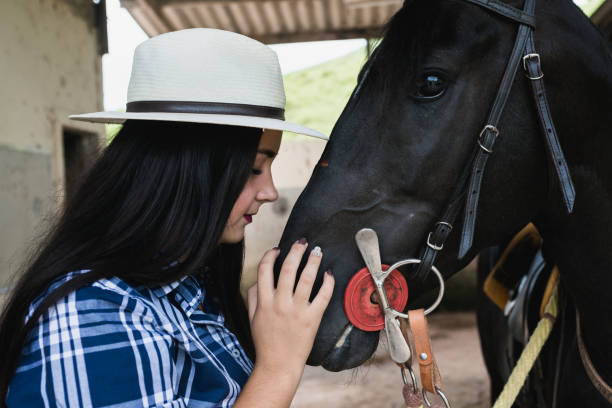 istock Cowgirl and a horse at ranch 949190014