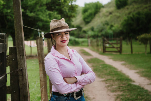 istock Young woman farmer at the gate 949190080