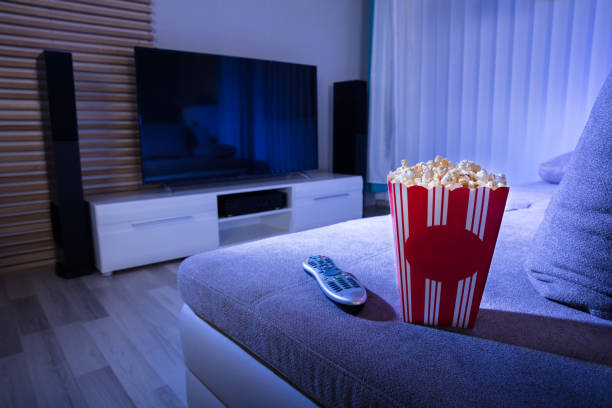 istock Close-up Of Popcorn And Remote Control On Couch 949190234