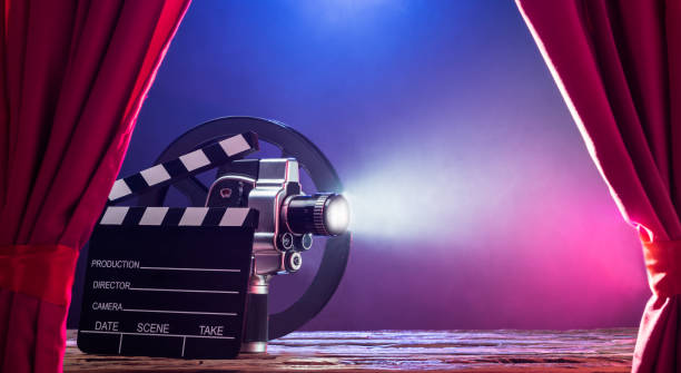 istock Movie Camera With Clapperboard And Film Reel On Stage 949190356