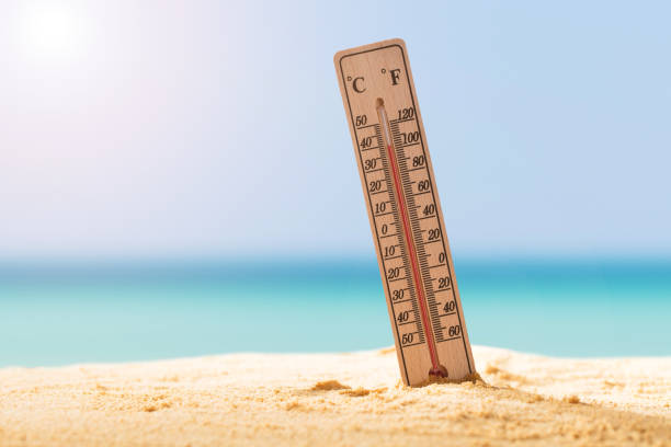 Close-up Of Thermometer On Sand Close-up Of Thermometer On Sand Showing High Temperature celsius stock pictures, royalty-free photos & images