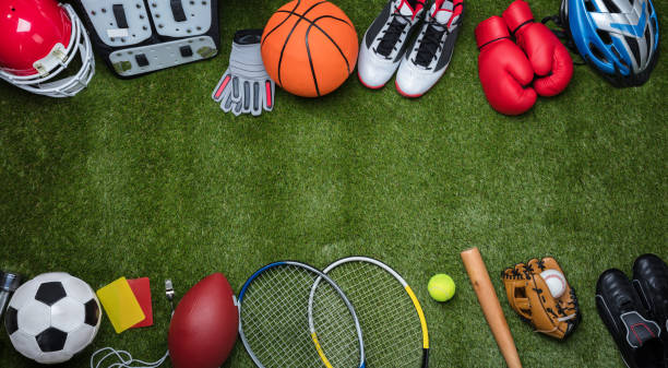 Various Sport Equipments On Grass High Angle View Of Various Sport Equipments On Green Grass team sport stock pictures, royalty-free photos & images