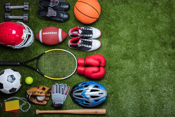 Various Sport Equipments On Grass High Angle View Of Various Sport Equipments On Green Grass base sports equipment photos stock pictures, royalty-free photos & images