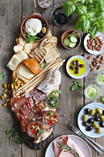 istock Mediterranean appetizers table concept. Diner table with tapas selection: cured meat and salami, gazpacho soup, jamon, olives, cheese, hummus and vegetables. 949190776