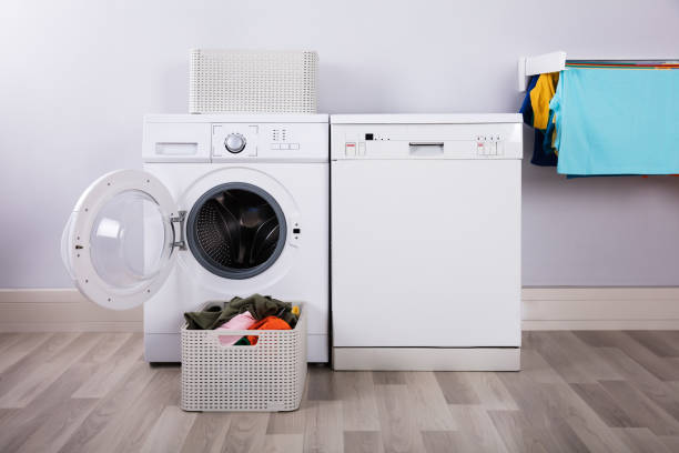 istock Empty Washing Machine With Pile Of Dirty Clothes 949190984