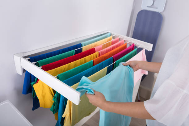 istock Woman Hanging Clothes On Clothes Line 949190990