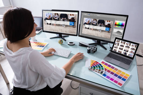 Female Designer Working On Multiple Computer Close-up Of A Female Designer Working On Multiple Computer At Workplace image manipulation stock pictures, royalty-free photos & images