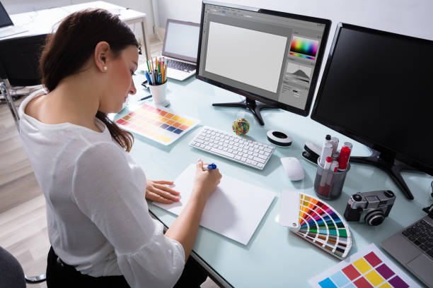 istock Female Designer Drawing On Blank Placard 949195716