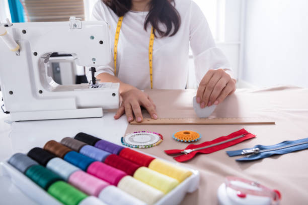 istock Fashion Designer Measuring Fabric With Ruler 949195918