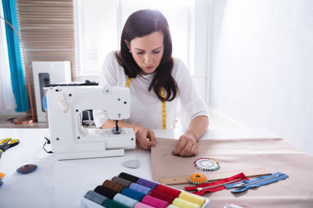 istock Fashion Designer Sewing Fabric With Needle 949195932