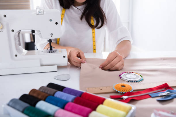 istock Fashion Designer Measuring Fabric With Ruler 949195942
