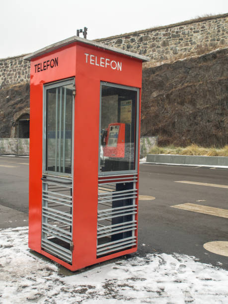 Oslo, Norway - February 16, 2017: A red telephone booth on a street in Oslo